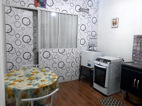 尼泰罗伊Loft aconchegante - Centro Niterói的厨房配有炉灶、桌子和炉灶。 顶部烤箱