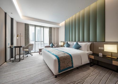 成都秦皇永安精品酒店的酒店客房设有一张大床和一张书桌。
