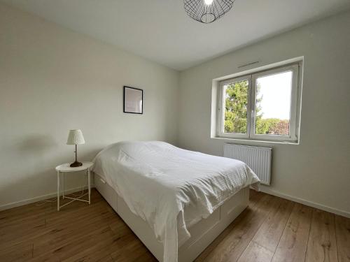 泰昂维Lumineux Apt 1BR Type Loft Proche Centre的白色的卧室设有床和窗户