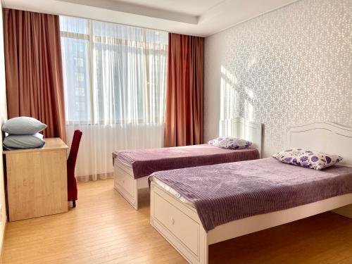 阿斯塔纳Хайвилл Астана的酒店客房设有两张床和窗户。