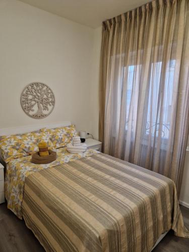 瓦拉泽Appartamento centralissimo,a 20 mt dal mare的一间卧室配有一张带毯子的床和窗户
