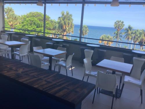 圣多明各HOTEL BLUE MALECÓN的一间带桌椅的海景餐厅