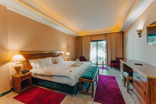 马拉喀什Palace Jena的配有一张床和一张书桌的酒店客房
