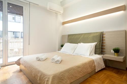 雅典KUKAKI ESTATE 2的一间卧室配有一张床,上面有两条毛巾