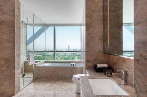 银川银川万怡酒店的一间带水槽和卫生间的浴室以及窗户。