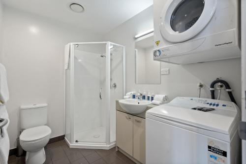 奥克兰曼努考/奥克兰机场近邻公寓的白色的浴室设有卫生间和水槽。