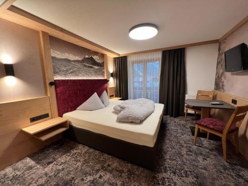图克斯珍妮韦恩霍夫酒店的酒店客房配有一张床铺和一张桌子。