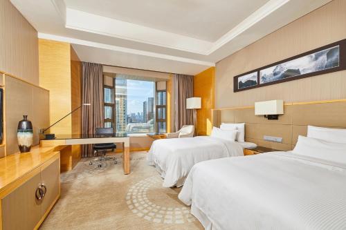福州福州天元国际威斯汀酒店的酒店客房配有两张床和一张书桌