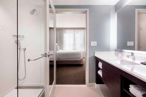 沃特敦波士顿水城万豪原住客栈 的带淋浴和盥洗盆的浴室以及1张床。