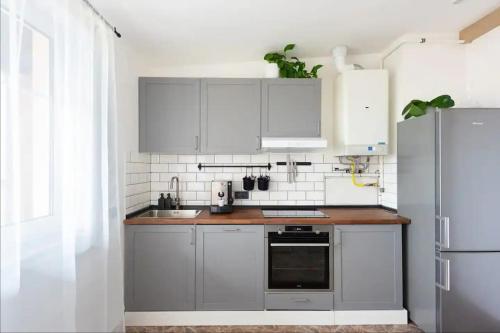 布拉格Huge 5-bedrooms apartment near Prague Castle的厨房配有白色橱柜和不锈钢冰箱