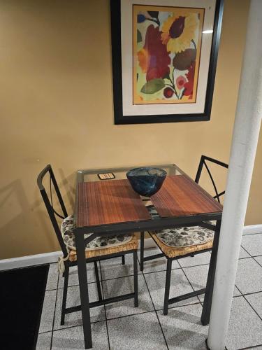 皇后区Tidy Queens Apartment的餐桌,两把椅子和碗