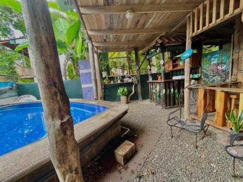 塔尔科莱斯Hostel Rústico MarAbi的庭院设有游泳池、桌子和椅子