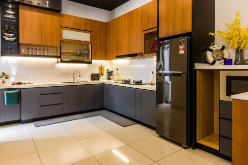 大山脚Varnen Cozy Haven的厨房配有木制橱柜和黑色冰箱。