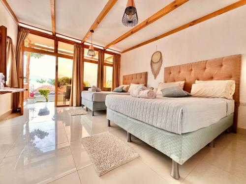圣佩德罗拉拉古纳Sababa Resort的一间卧室设有两张床和大窗户