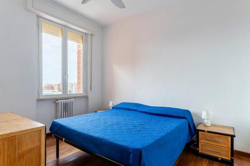 利沃诺Roomy Flat near the Hospital Riuniti with Parking!的一间卧室设有蓝色的床和窗户。