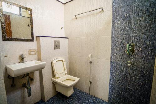 斋浦尔HOTEL ATHITI INN JAIPUR的浴室配有卫生间、盥洗盆和淋浴。