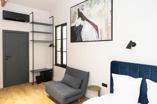 尼斯Centrum Nice的一间卧室配有一张床和一把椅子