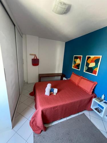 萨尔瓦多Apartamento Auge da Bahia的一间卧室设有红色的床和蓝色的墙壁