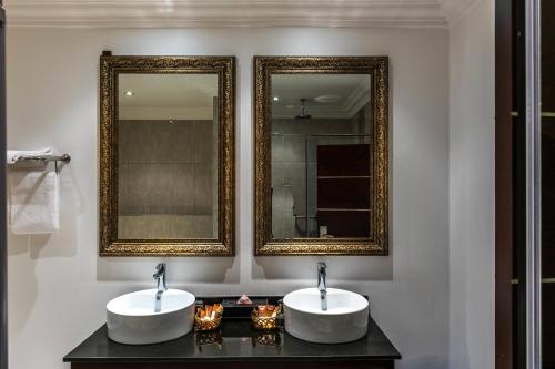 拉各斯拉各斯库拉莫水万豪Protea酒店的浴室设有2个水槽和2个镜子
