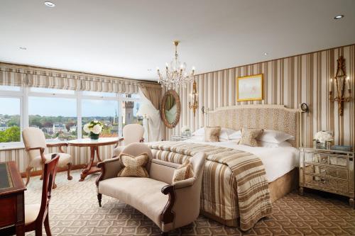 圣彼得港列治文公爵酒店的一间卧室配有一张大床和一张桌子及椅子