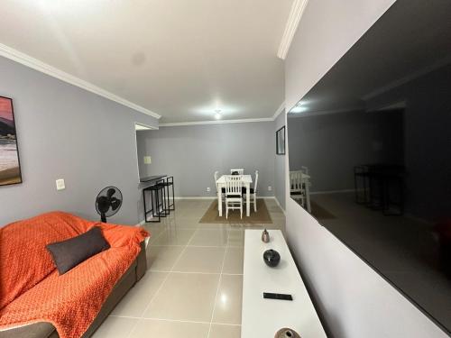 里约热内卢Suites W-Riocentro的客厅配有床和桌子