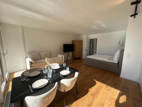 康斯坦茨Urban Lodges - Studio Apartments am Seerhein的客厅配有桌椅和沙发