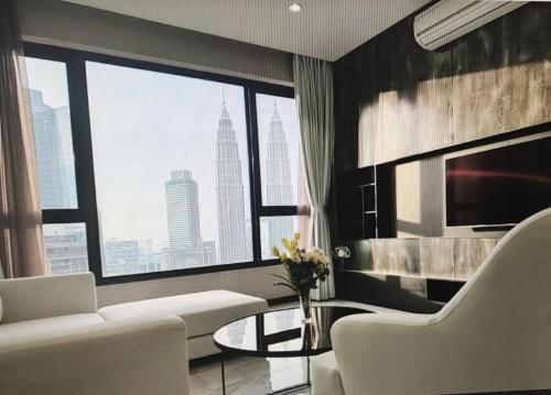 吉隆坡8 Kia Peng Suites KLCC by Luna的客厅配有白色沙发和大窗户