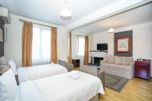第比利斯Beaumonde Hotel Tbilisi的一间带两张床的卧室和一间客厅