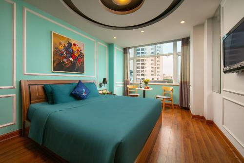 河内Hai Mươi Hotel & Apartment的一间卧室配有一张蓝色的床和一张桌子