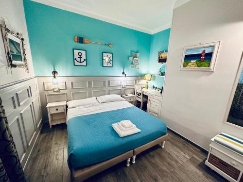 西维尔诺瓦·马尔凯AlCivico3的一间卧室配有一张蓝色墙壁的床和一张书桌