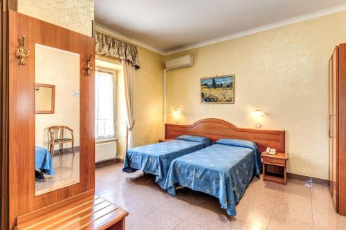 罗马米洛酒店的一间卧室配有两张蓝色床单