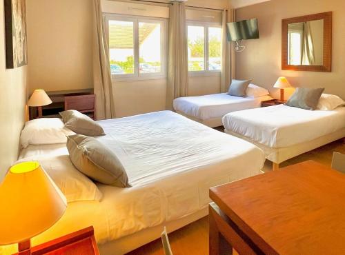 朗布依埃Villa Rambouillet的酒店客房设有两张床和窗户。