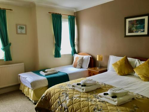 牛津匹克维克旅馆的绿窗帘间内的两张床