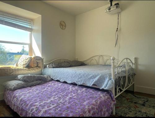 奥斯汀Mella House的一间卧室配有一张床、一张沙发和一个窗口