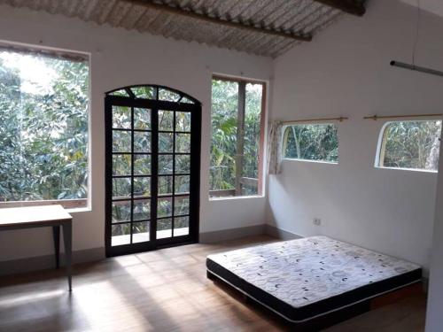 圣罗克Tranquilidade e conforto na floresta - Rota do Vinho的一间设有床铺的卧室,位于带窗户的房间内