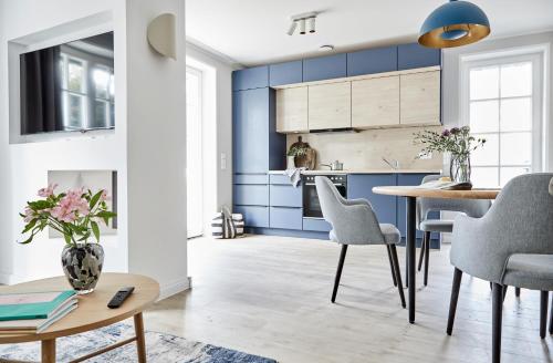 普雷罗Strandglück Prerow的厨房配有蓝色橱柜和桌椅