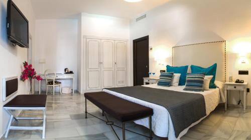 贝纳尔马德纳拉芬达酒店的一间卧室配有一张带蓝色枕头的大床