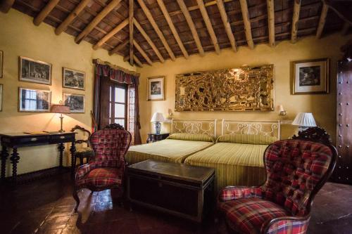 查兹拉德拉谢拉圣贝尼托宫酒店的一间卧室配有一张床和两把椅子