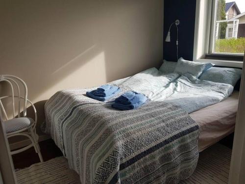 YtterlandLeilighet i enebolig på Valderøya ved Ålesund的卧室内的一张床位,上面有两条蓝色的毛巾