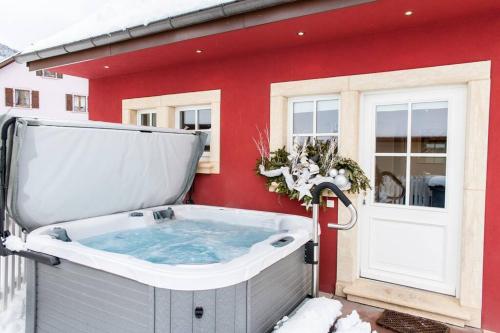 瑟温Doller Villa 4 stars Hot Tub Mountain Ski Ballon d'Alsace的雪中房子外的热水浴池