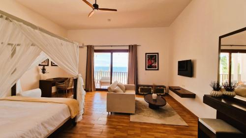 乌罗阿Dream of Zanzibar Resort & Spa - Premium All Inclusive的一间卧室配有一张床,享有海景
