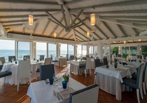 萨包迪亚奥西蒂库佛酒店的一间设有白色桌椅的海洋餐厅