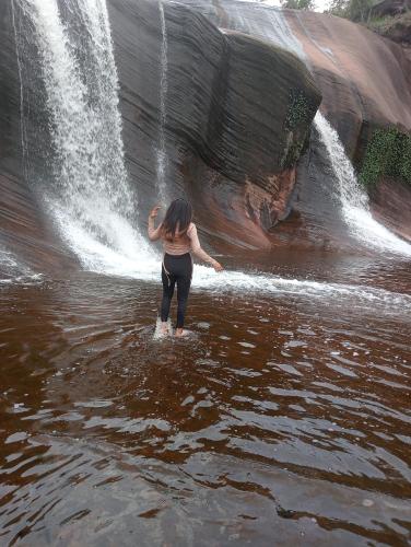 Ban Non Sungรี่สอตน้ำตกถ้ำพระ的站在瀑布前的水面上的女人