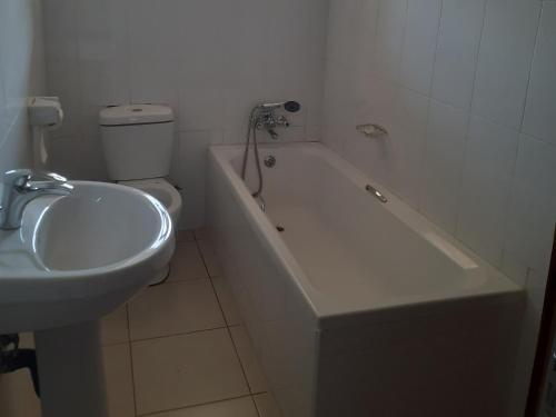 利隆圭Amethyst bed and breakfast的浴室配有卫生间、浴缸和水槽。