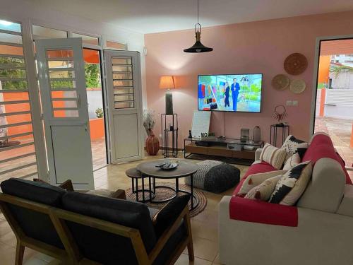 勒罗贝尔Villa Norah modulable T3 avec piscine的带沙发和电视的客厅