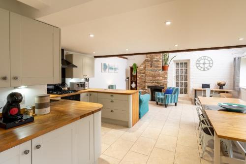 牛津Colthorn Farm Cottage By Aryas Properties - Oxford的厨房以及带桌椅的起居室。