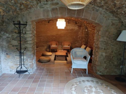 佩拉托拉达Casa Peratallada的石墙内的房间,配有椅子和桌子