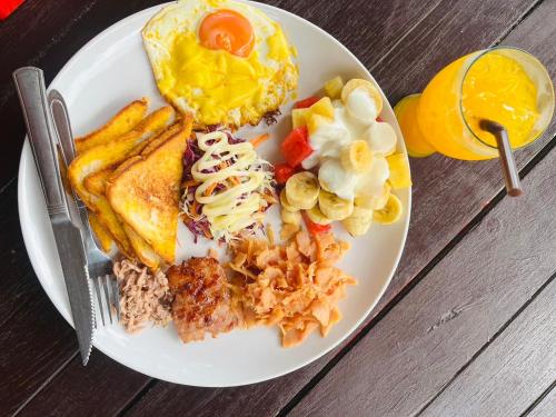 班柯木柯木海景简易别墅旅馆的包括鸡蛋烤面包和水果的早餐盘