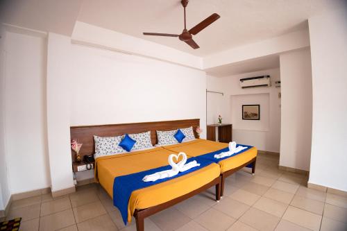 蓬蒂切里VKG Hotels的一间卧室配有一张蓝色和黄色的床罩
