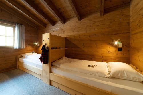 维尔德豪斯Chalet Selun的小木屋内一间卧室,配有两张床